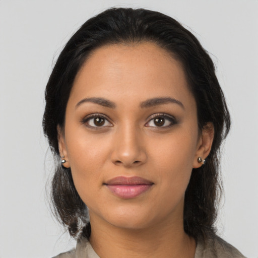 Joyful latino young-adult female with long  black hair and brown eyes