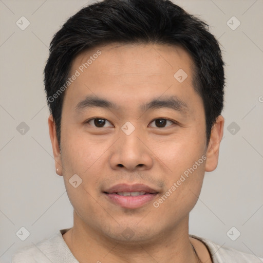 Joyful asian young-adult male with short  black hair and brown eyes