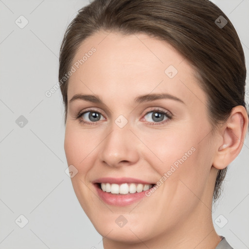 Joyful white young-adult female with medium  brown hair and grey eyes