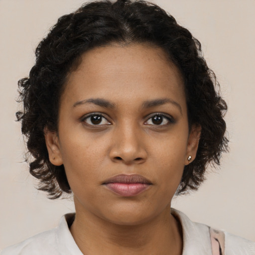 Neutral black young-adult female with medium  brown hair and brown eyes