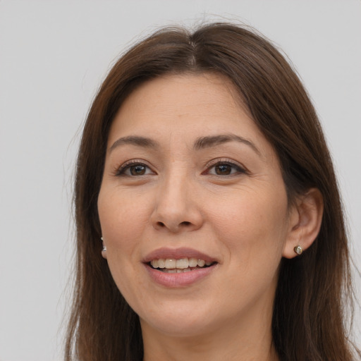 Joyful white adult female with long  brown hair and brown eyes