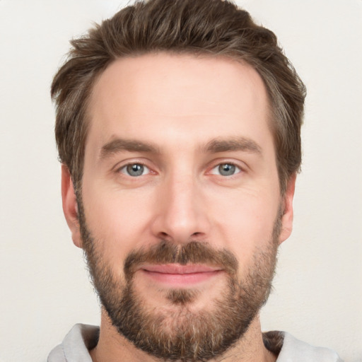 Joyful white adult male with short  brown hair and brown eyes