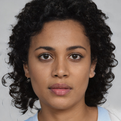 Neutral black young-adult female with medium  brown hair and brown eyes