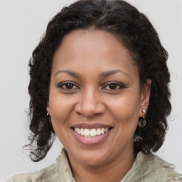 Joyful black adult female with medium  brown hair and brown eyes