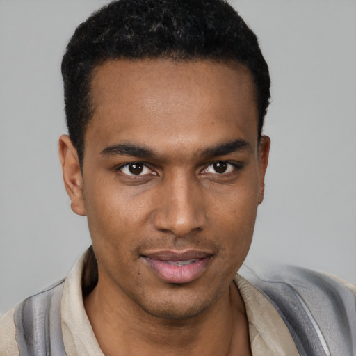 Joyful black young-adult male with short  black hair and brown eyes