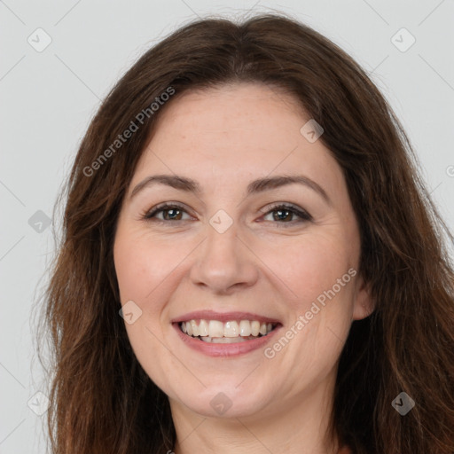 Joyful white adult female with long  brown hair and brown eyes