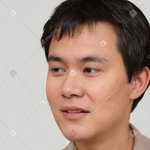 Joyful white young-adult male with short  black hair and brown eyes