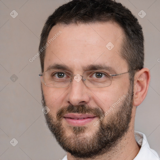 Joyful white adult male with short  brown hair and brown eyes