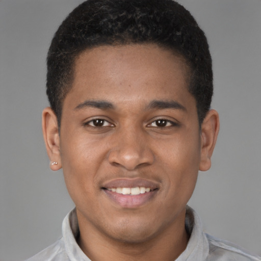 Joyful latino young-adult male with short  brown hair and brown eyes