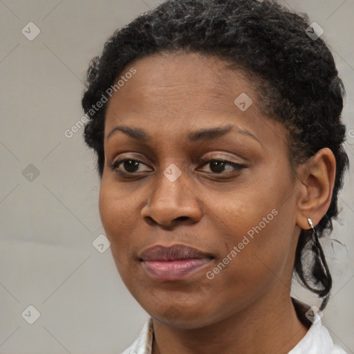 Joyful black young-adult female with short  brown hair and brown eyes