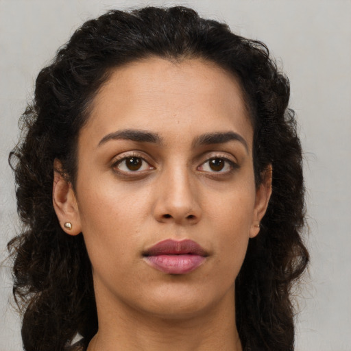 Neutral latino young-adult female with long  brown hair and brown eyes