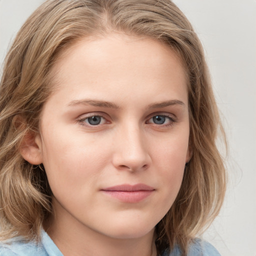 Joyful white young-adult female with long  brown hair and blue eyes