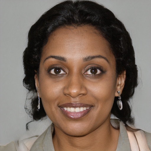 Joyful black young-adult female with long  brown hair and brown eyes