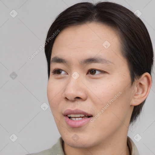 Joyful asian young-adult male with short  brown hair and brown eyes