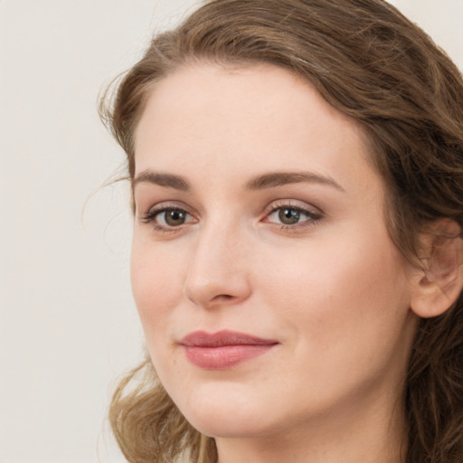 Joyful white young-adult female with long  brown hair and green eyes