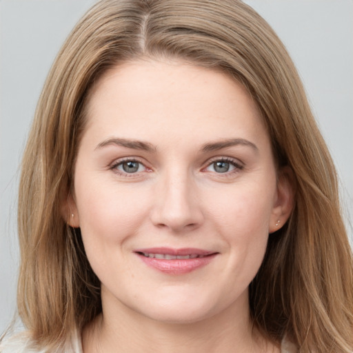 Joyful white young-adult female with long  brown hair and grey eyes