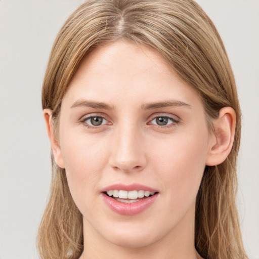 Joyful white young-adult female with long  brown hair and green eyes