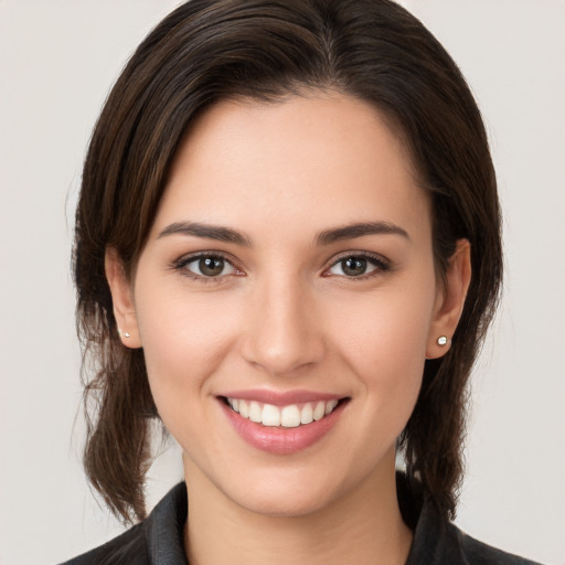 Joyful white young-adult female with medium  brown hair and brown eyes