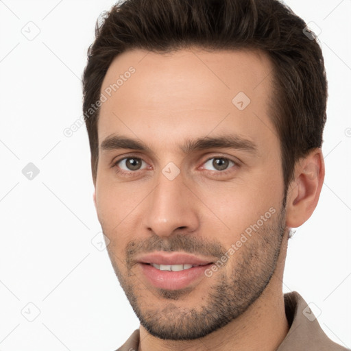 Joyful white young-adult male with short  brown hair and brown eyes