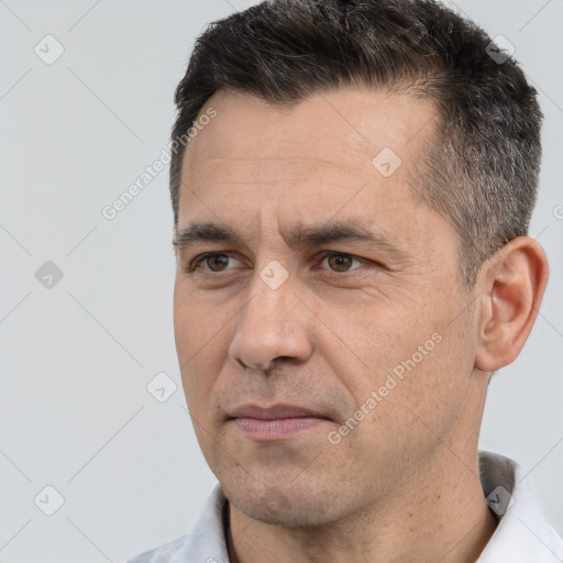 Joyful white adult male with short  black hair and brown eyes