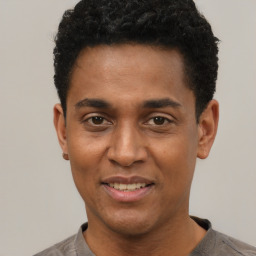 Joyful black young-adult male with short  black hair and brown eyes