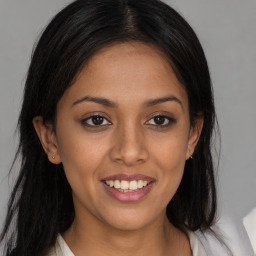 Joyful latino young-adult female with long  brown hair and brown eyes