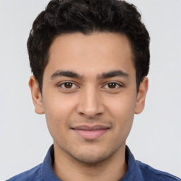 Joyful latino young-adult male with short  brown hair and brown eyes