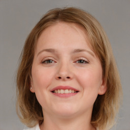 Joyful white young-adult female with medium  brown hair and blue eyes