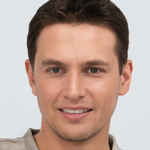 Joyful white young-adult male with short  brown hair and brown eyes