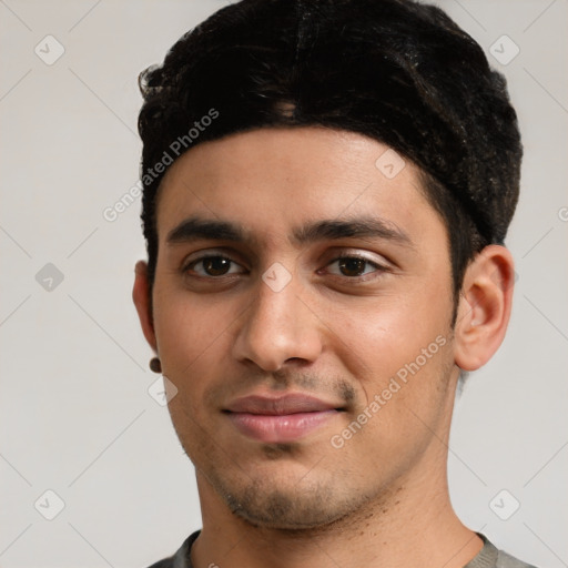 Joyful latino young-adult male with short  black hair and brown eyes