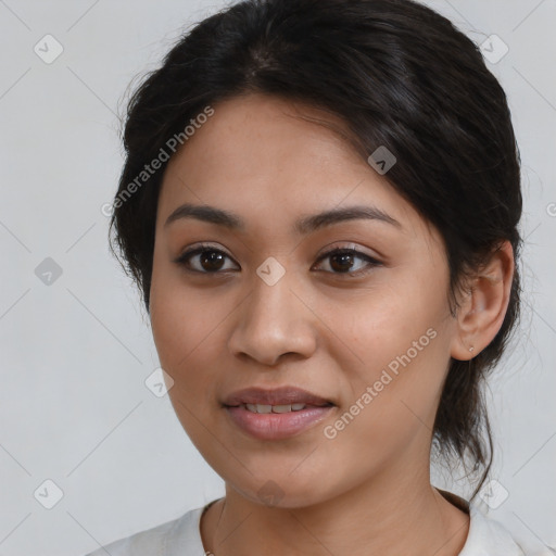 Joyful latino young-adult female with medium  brown hair and brown eyes