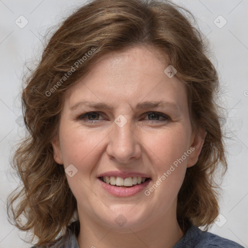 Joyful white adult female with medium  brown hair and grey eyes