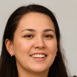 Joyful white young-adult female with long  brown hair and brown eyes