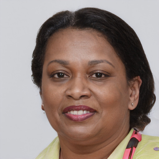 Joyful black adult female with medium  brown hair and brown eyes
