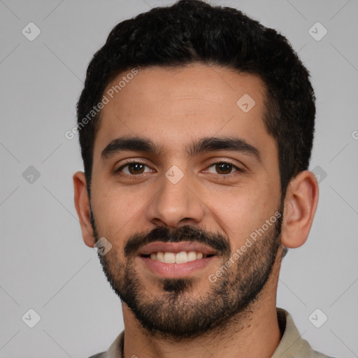 Joyful latino young-adult male with short  black hair and brown eyes