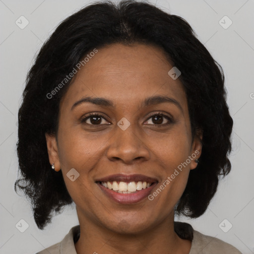 Joyful black adult female with medium  brown hair and brown eyes