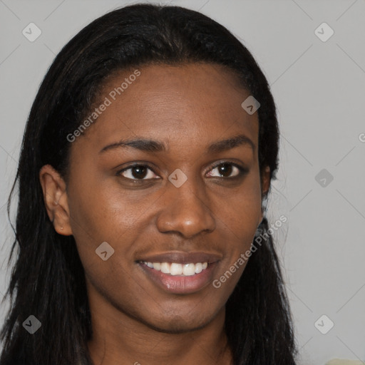 Joyful black young-adult female with long  brown hair and brown eyes