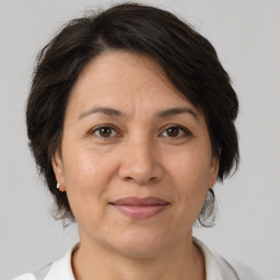 Joyful white adult female with medium  brown hair and brown eyes