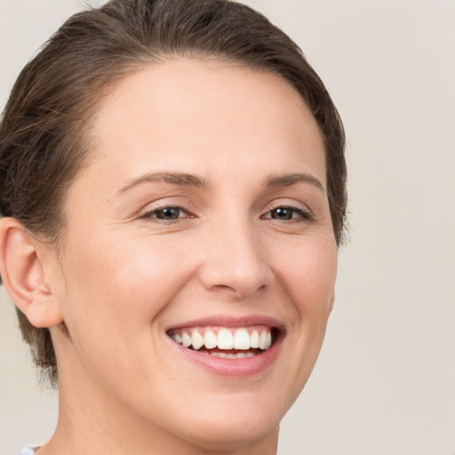 Joyful white young-adult female with medium  brown hair and brown eyes