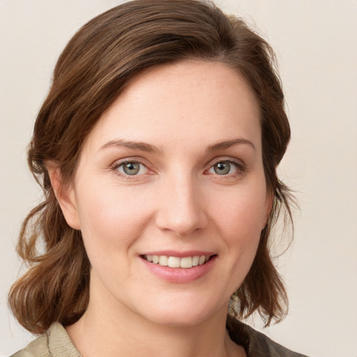 Joyful white young-adult female with medium  brown hair and blue eyes