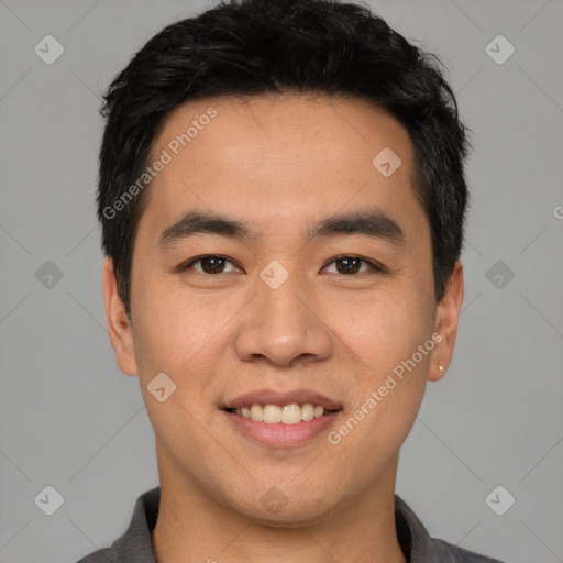 Joyful asian young-adult male with short  black hair and brown eyes