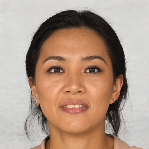 Joyful asian young-adult female with medium  black hair and brown eyes
