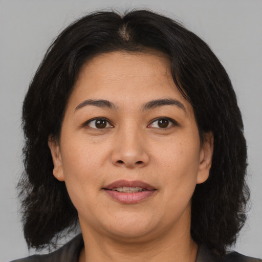 Joyful asian adult female with medium  brown hair and brown eyes