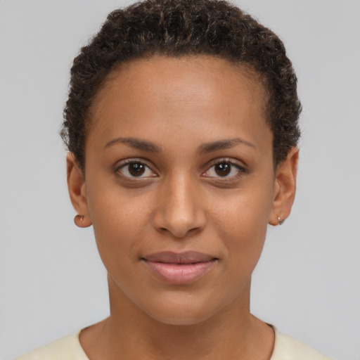 Joyful black young-adult female with short  brown hair and brown eyes