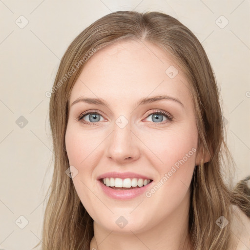 Joyful white young-adult female with long  brown hair and green eyes