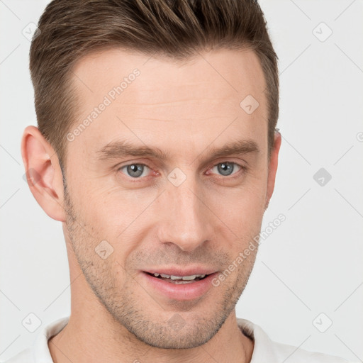 Joyful white young-adult male with short  brown hair and grey eyes