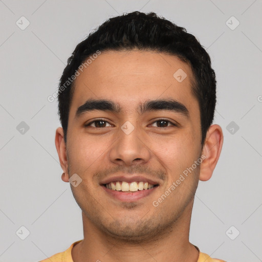 Joyful latino young-adult male with short  black hair and brown eyes