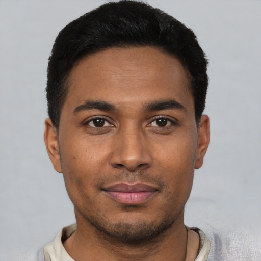 Joyful latino young-adult male with short  black hair and brown eyes