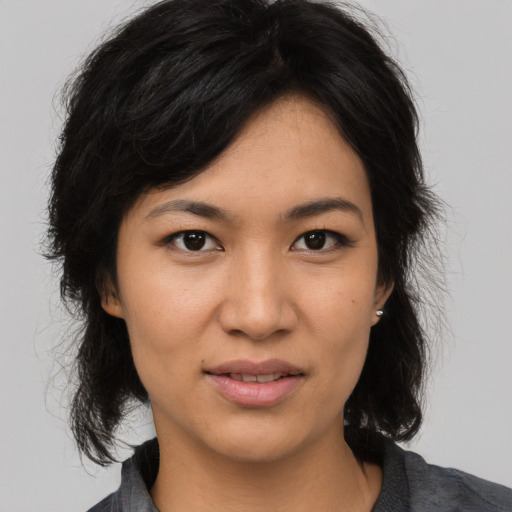Joyful asian young-adult female with medium  black hair and brown eyes