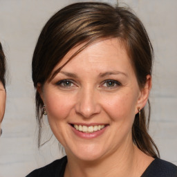 Joyful white adult female with medium  brown hair and brown eyes